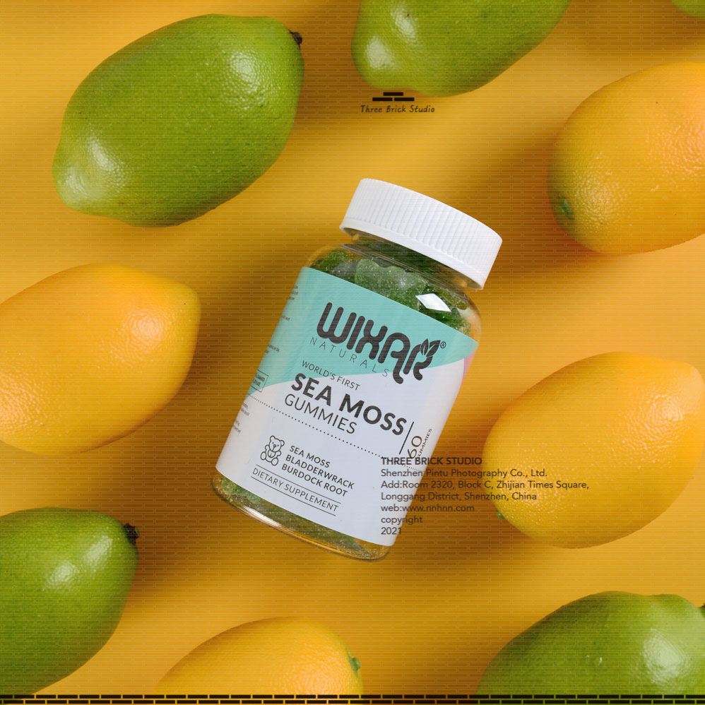 Product photography in China Vitamin Green Bear 1 bottle lies in the middle of green and yellow lemon