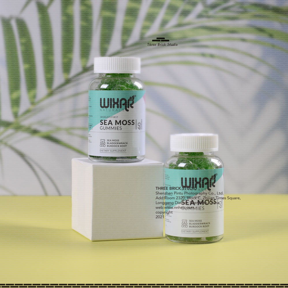 Product Photography in China Vitamin green bear lifestyle 2 bottles, leaf background